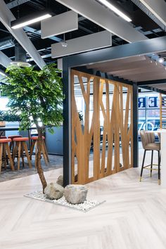 an office lobby with wooden doors and chairs