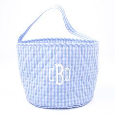 a blue and white gingham basket with monogrammed letters