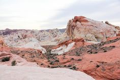 the desert is filled with red and white rocks