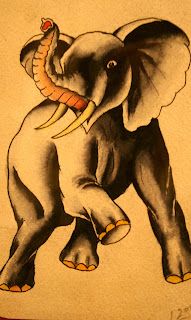 an elephant with a snake on its back