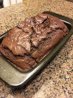 a loaf of chocolate cake sitting on top of a counter