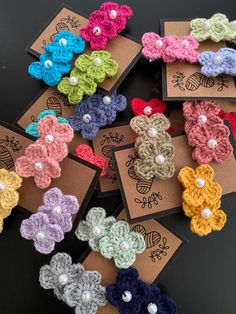 small crocheted flowers with pearls on them are displayed in different colors and sizes