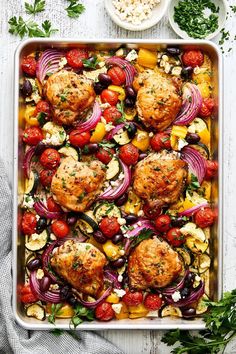 chicken meatballs with tomatoes, onions and olives in a casserole dish