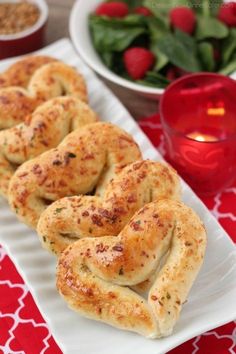 two white plates filled with bagels on top of a red and white table cloth