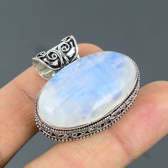 Note: Due to the natural formation of this gemstone. Slight variation in design and color are to be expected. Rainbow Moonstone Pendant 925 Sterling Silver Pendant Handmade Ethnic Jewelry Real Gemstone Pendant Anniversary Gift For Mom Vintage Pendant SKU  : VP-312 Handmade Pendant Gemstone :  Rainbow Moonstone Stone Shape : Oval Metal Purity : 925 Sterling Silver Pendant Length : 33 MM Pendant Width : 38 MM Rainbow moonstone is thought to bring balance, harmony and hope while enhancing creativit Bohemian Moonstone Cabochon Jewelry, Bohemian Moonstone Gemstone Jewelry, Bohemian Jewelry With Large Moonstone, Bohemian Moonstone Jewelry With Large Stone, Handmade Silver Moonstone Gemstones, Bohemian Silver Jewelry With Large Stone, White Moonstone Gemstones With Spiritual Style, Bohemian Oval Moonstone Jewelry, White Bohemian Jewelry With Cabochon