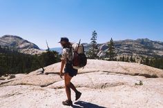 a person with a backpack walking on top of a mountain