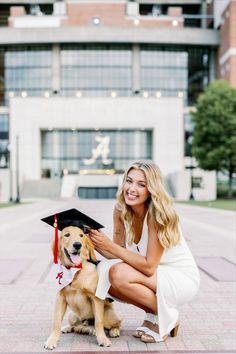 a woman kneeling down next to a dog wearing a graduation cap