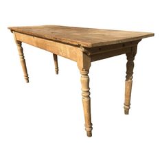 an old wooden table with turned legs