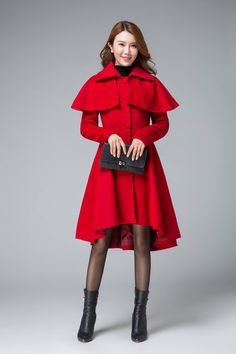 "Chic and classic, this woman's red wool cape coat features a beautiful pleated skirt with drop hem in front, making it ultra feminine. The romantic coat designed with a removable capelet, it will keep you warm in the winter. Details: * 50% wool blend fabric * Polyester lining * long sleeves * two side pockets * buttons fasten front * with a cape can be moved off * high low hem * lapel collar SIZE GUIDE Size vary between Brand and Country Please get your body measurement with our Size Guide And Womens Cape Coat, Capelet Coat, High Low Coat, Mantel Cape, Fit And Flare Coat, Wool Cape Coat, Wool Winter Coat, Black Wool Coat, Outwear Coat