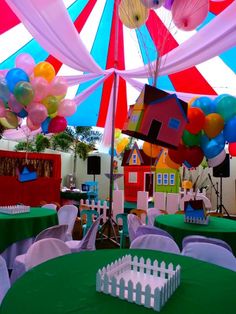 an outdoor party with colorful balloons and decorations