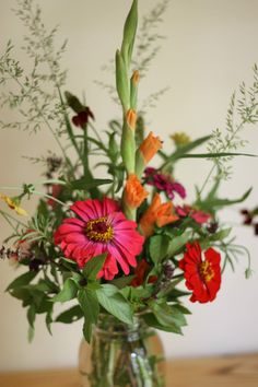 a vase filled with flowers on top of a wooden table