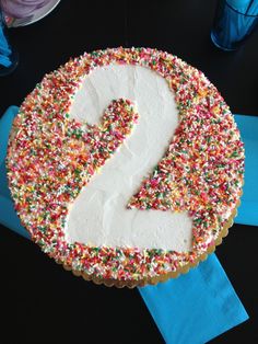 a birthday cake with sprinkles and the number 2 on it