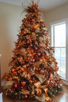 a christmas tree decorated with gold and red ornaments