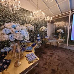 a room filled with lots of blue and white flowers next to a wall covered in frosting