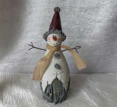 a ceramic snowman with a red hat and scarf