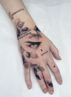 a woman's hand with tattoos on it