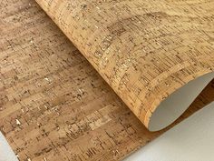 closeup of cork flooring with white wall and wood grains on the surface