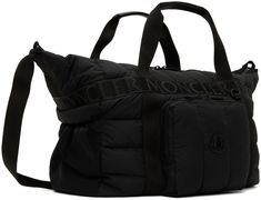 Water-repellent quilted down-filled nylon taffeta duffle bag in black. Logo-woven webbing trim throughout. · Twin carry handles · Adjustable webbing shoulder strap · Zip compartment and logo patch at face · Elasticized mesh pocket at sides · Two-way zip closure · Zip pocket at interior · Logo-woven twill lining · Logo-engraved black hardware · H15 x W18.5 x D6 in Supplier color: Black Fill: 90% down, 10% feathers. Nylon Bags With Logo For Outdoor Activities, Designer Quilted Nylon Bags, Outdoor Nylon Bags With Logo, Sporty Nylon Bag With Logo Patch, Luxury Nylon Bags With Logo Patch, Nylon Travel Bag With Logo Patch, Interior Logo, Black Hardware, Travel Luggage