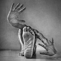 two hands reaching out to each other with one hand on the ground, while another is holding