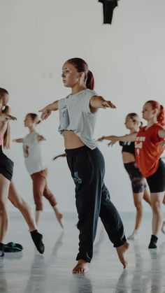 a group of young women dancing in a dance studio