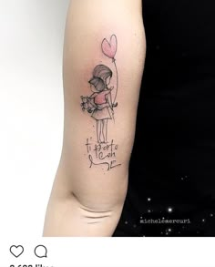 a girl with a heart balloon tattoo on her arm