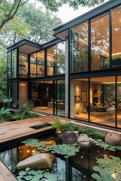 the house is surrounded by water lilies and trees