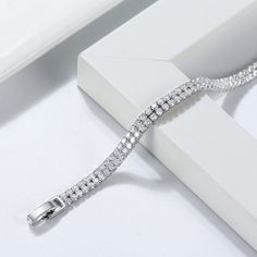 This glamorous 4mm tennis bracelet is crafted in lustrous sterling silver. This alluring bracelet features two rows of shimmering created white Cubic Zirconia is beautifully arranged in a tennis style. Our bracelet is cheap and made with the greatest attention to quality and minutest details and enhances with the best high polish finish, Its stunning sparkle design with precision craftsmanship gives you a beautiful bracelet to wear and admire without being too loose This beautiful bracelet is th Silver Link Chain, Bracelets Design, Silver Chain Style, Minimalist Bracelet, Bangles Jewelry, Tennis Bracelet, Chain Link Bracelet, Chains Jewelry, Bracelet Designs