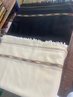 This classic Swat-Islampuri woolen shawl is hand knitted by skilled artisans in the Swat Valley of Pakistan. It is made from pure wool, which makes it warm and comfortable to wear. The shawl is available in a variety of colors, so you can choose one that matches your style. It is perfect for keeping you warm in the winter or for adding a touch of elegance to your outfit. Here are some additional details that you can include in your description: The shawl is made from 100% pure wool. It is hand k Traditional White Scarves For Winter, Traditional Winter Shawl For Gift, Traditional White Winter Scarves, Traditional Winter Shawl, Traditional Pashmina Shawl With Traditional Patterns For Winter, Traditional Handloom Pashmina Shawl For Winter, Traditional Handwoven Black Shawl, Traditional Winter Shawl With Patterns, Traditional Winter Shawl With Traditional Patterns