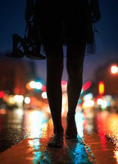 a person walking down the street in the rain