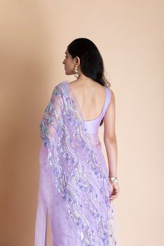 Editor's Note Featuring a lavender hand-embroidered silk organza saree. This comes with matching unstitched blouse piece in chanderi and matching underskirt fabric in shampoo. Color: Lilac Fabric: Silk Organza Length: Saree Length: 5.5m; Blouse Fabric: 1m Care: Dry Clean Only About the Designer Saksham & Neharicka make modernizing Indian wear with rich handwoven textiles, fresh intricate textures, chic and classic silhouettes, Saksham & Neharicka handcraft all designs to eternal perfection. Thei Transitional Embroidered Organza Pre-draped Saree, Purple Silk Pre-draped Saree For Wedding, Fitted Embroidered Organza Fabric For Saree, Purple Chanderi Pre-draped Saree For Wedding, Embroidered Purple Georgette Pre-draped Saree, Purple Chanderi Pre-draped Saree For Reception, Purple Tissue Silk Pre-draped Saree For Reception, Elegant Lavender Sets With Sheer Dupatta, Unstitched Embroidered Organza Blouse For Reception