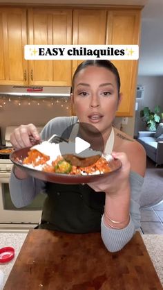 a woman is holding a plate of food in her hands and the words easy chilaquilies on it