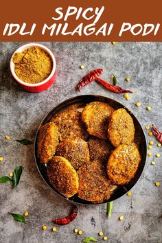 some food that is in a bowl on a table with spices and seasonings around it