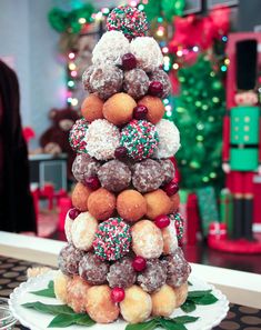 a christmas tree made out of doughnuts and sprinkles on a plate