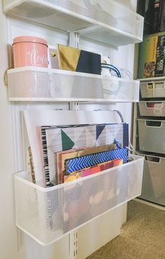 the shelves are filled with various items and storage bins for crafting or sewing