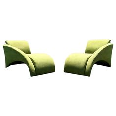 two green chairs sitting next to each other