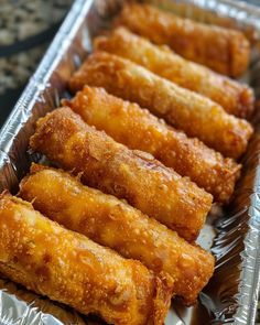 some fried food is sitting on tin foil