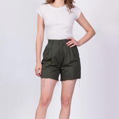 Vintage 90s high waisted olive green cotton pleated shorts by Wrangler Casual, with a raw cut-off hem. Measurements and Condition: Fits like: Labeled size 4, fits modern women's extra small (can fit a larger hip) Fabric: Cotton Brand: Wrangler Casual Condition: Very good, with light general wear Waist: 25" Hips: 40" - taken at the bottom of the zipper opening Rise: 12.5" Inseam: 5.5" Shown on a 5'8" model with measurements of 34"-26"-37", usually wears a size small. See our FAQ section for more information on sizing and condition ratings. Vintage Wrangler, Vert Olive, Pleated Shorts, Mom Shorts, Cut Off Shorts, Green Cotton, Cut Off, Fabric Cotton, Modern Woman