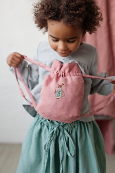 Backpack is made from 100% soft and washed linen. Perfect for kids toys, storage, laundry, as a traveling bag, gift bag or nursery decor. Details: - Choose size and colour in the drop down menu - Embroidery: rabbit girl - Composition: 100% Oeko-Tex certified linen - Medium weight linen - Linen care: machine wash gentle; tumble dry low, ironing optional - Since all the embroideries are made by hand, note that the embroidery will be unique and a little bit different each time. Colours can differ a Backpacks For Kids, Kids Toy Storage, Drawstring Bag Pattern, Baby Apron, Rabbit Girl, Linen Pinafore, Girl Embroidery, Toy Storage Bags, Kids Backpack