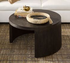 a coffee table with beads on it in front of a white couch