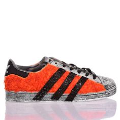 Adidas Superstar Orange Side is the perfect custom men's sneaker for winter! Covered in soft teddy-effect fabric in fluorescent orange, this model is made even bolder and edgier by the washed effect and the iconic Adidas stripes in black faux leather with matching studs. The look of the Adidas Superstar Orange Side is completed with flat black waxed laces. Adidas Sporty Orange Custom Sneakers, Sporty Orange Adidas Sneakers, Orange Adidas Sneakers For Streetwear, Adidas Orange Sneakers For Sports, Adidas Orange Leather Sneakers, Ysl Sandals, Soft Teddy, Margiela Shoes, Expensive Handbags