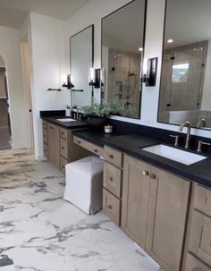 a large bathroom with double sinks and mirrors