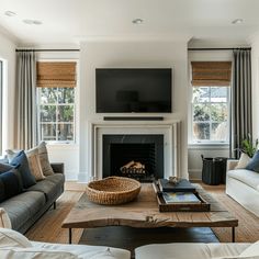 a living room filled with furniture and a flat screen tv mounted above a fire place