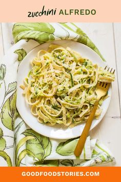 a white plate topped with pasta and broccoli