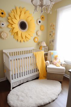 a baby's room decorated in yellow and white with sunflowers on the wall