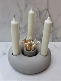 some candles are sitting in a holder on a table