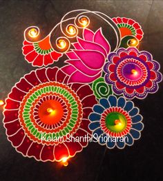 colorful diya with lit candles in the middle