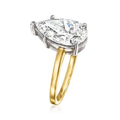 a yellow and white gold ring with an oval cut diamond