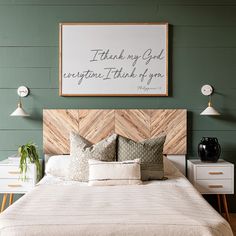 a bedroom with green walls and wooden headboard