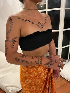 a woman with tattoos on her arm and chest