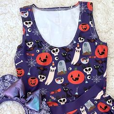 a purple top with halloween decorations on it